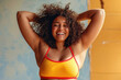 Exuberant young woman with curly hair enjoying a carefree moment, dressed in a vibrant swimsuit.