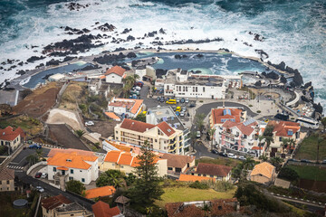 Wall Mural - aerial view of porto moniz, madeira, island, natural swimming pools, lava, stormy sea, waves, portugal