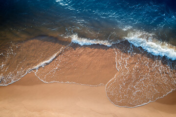 Poster - Relaxing aerial beach scene, summer vacation holiday template banner. Waves surf with amazing blue ocean lagoon, sea shore, coastline. Perfect aerial drone top view.