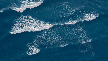 Wall Mural - Sea blue surface aerial view, abstract blue sea water with white wave for background