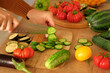 © Marina Demidiuk - Woman using a knife cutting fresh raw vegetables. Tomatoes, cucumbers being sliced on a wooden board. Cooker at home making a healthy veggie meal. Chopping ingredients for preparing vegetarian dish 4K