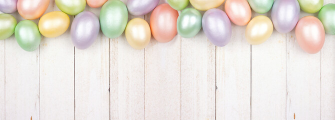 Poster - Easter Egg top border over a white wood banner background. Shiny pastel eggs. Copy space.