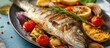 Grilled fish accompanied by vegetables.