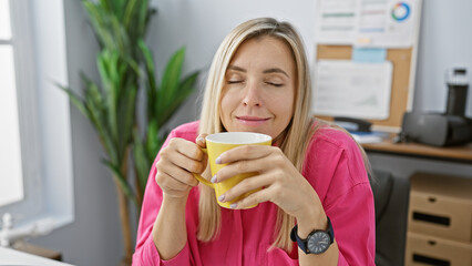 Sticker - A young woman enjoys a coffee break at her office, radiating casual professionalism and relaxation.