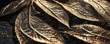 There Are Many Golden Leaves On A Black Surface