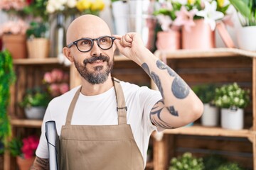 Canvas Print - Young bald man florist smiling confident holding binder at florist