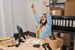 © Krakenimages.com - Young beautiful plus size woman ecommerce business worker stretching arms yawning at office