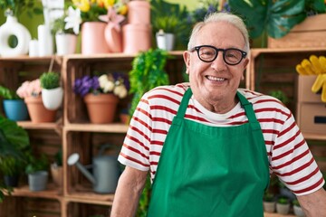 Sticker - Middle age grey-haired man florist smiling confident standing at flower shop