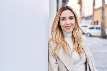 Poster - Young blonde woman smiling confident standing at street