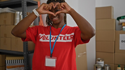 Poster - African american woman volunteer smiling confident doing heart gesture at office