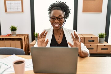 Canvas Print - African american woman call center agent smiling confident speaking at office