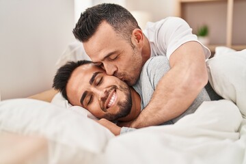 Poster - Two men couple lying on bed hugging each other kissing at bedroom