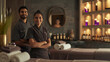 © sderbane - Beautiful indian young woman and man working at hotel in spa department and greeting guests.