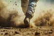 A runner's fierce determination kicks up a cloud of dust, echoing the intensity of their race against time and terrain.