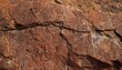 Dark red-orange-brown rock texture with cracks