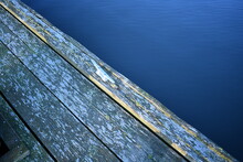 Boat Tie Down, Old Wooden Decking, Blue Water.