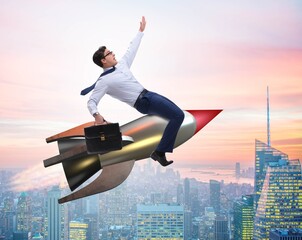 Wall Mural - Businessman flying on rocket in business concept