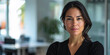 © JuanM - Confident latin businesswoman portrait at her office with copy space