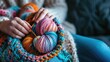 Colorful yarn balls with knitting needles and work in progress