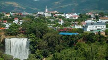 Elephant Waterfall And Da Lat City District Houses Lam Dong Province, Vietnam - Aerial Pan Revealing