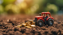A Toy Tractor Stands Beside Piles Of Golden Coins On Fertile Soil, Symbolizing The Growth And Investment In Agriculture