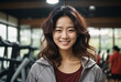 portrait of a young Asian woman in a gym