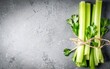 A stalk of fresh celery on the table. On a gray background