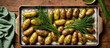 Fingerling potatoes in rustic sheet pan topped with green herbs, dressing and chives on the side, with green linen on wood surface. Banner, Background, Wallpaper, Copy Space, Widescreen, Marketing.
