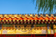 © DS Showcase - A Chinese architectural ornaments adorning the upper section of a traditional Chinese upper class house with delicate and colorful carvings under clear sky.