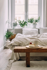 Wall Mural - Serving tray with breakfast on wooden bench against bedroom interior