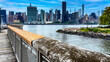 View of the New York skyline from the stone cliff pier and overlook of Long Island which is a large island that extends from the east of the Big Apple and Manhattan (USA).