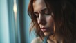Exhausted and sad woman alone at home near the window with closed eyes and depressed expression on face. Closeup portrait of adult female people with sadness. People and mental burnout problems life