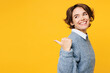 © ViDi Studio - Side view young happy woman wears grey knitted sweater shirt casual clothes point thumb finger aside on workspace area mock up isolated on plain yellow background studio portrait. Lifestyle concept.