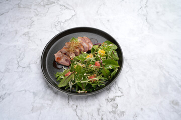 Wall Mural - Salad with duck breast, arugula leaves, orange, crushed walnuts