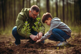 Fototapeta Miasta - Father and son planting a tree in the park, little boy helping his father plant a tree while working together on a sunny spring day, Earth Day