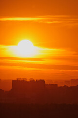 Wall Mural - Beautiful sunset over the city in the rays of the setting sun