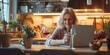 Smiling woman enjoying time on laptop in a cozy kitchen setting. warm and inviting home atmosphere captured. serene domestic life. AI