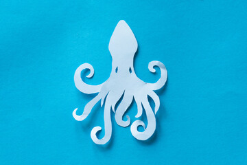 octopus paper cut out on blue background