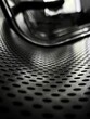close up of perforated steel seat in black and white