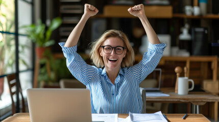 Poster - exuberant woman with tousled hair and glasses is raising her arms triumphantly in front of a laptop, expressing joy and success