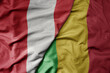 big waving national colorful flag of mali and national flag of peru .