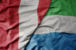 big waving national colorful flag of sierra leone and national flag of peru .