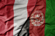 big waving national colorful flag of afghanistan and national flag of peru .