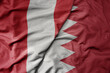 big waving national colorful flag of bahrain and national flag of peru .
