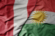 big waving national colorful flag of kurdistan and national flag of peru .