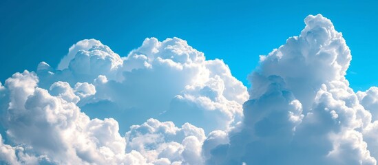 Wall Mural - Beautiful Blue Sky Background with White Clouds: A View of the Beautiful Blue Sky and Fluffy White Clouds Becoming the Perfect Background