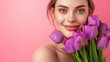 © AI Factory - Glowing Fresh-Faced Young Woman Embracing Spring with a Bouquet of Purple Tulips, Radiant Beauty and Wellness on a Delicate Pink Background
