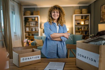 Wall Mural - One young adult woman prepare wardrobe clothes for charity donation