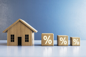 Poster - Creative wooden house blocks on blue background. Mortgage and loan investment concept. 3D Rendering.