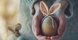 Celebrating Easter: hands holding adorable painted eggs with bunny ears and delicate painted faces, symbolizing spring and renewal